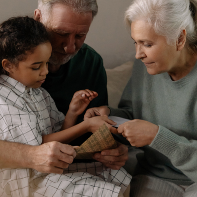 grandparents reading with their grandchild